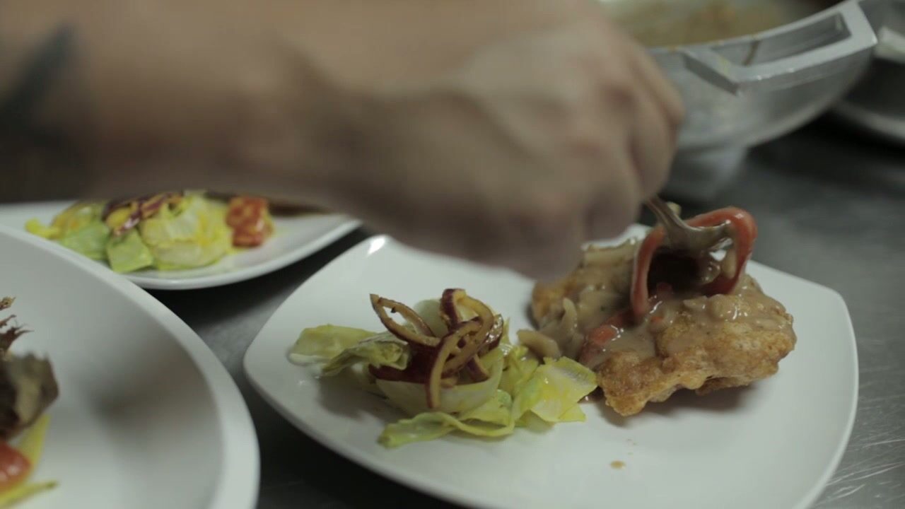 Sauce spooned over a plated dish